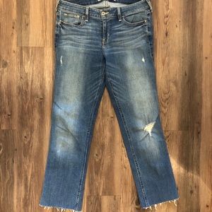 Medium wash jeans with frayed bottoms